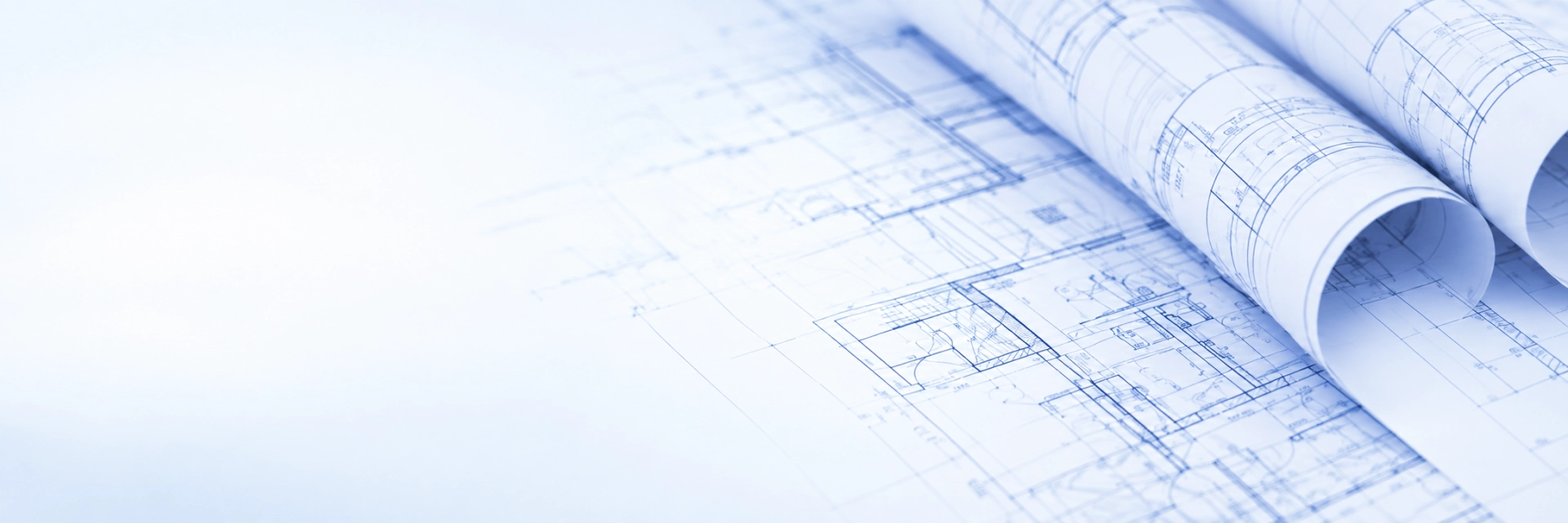 Roll of blueprints on top of a table, with a white background